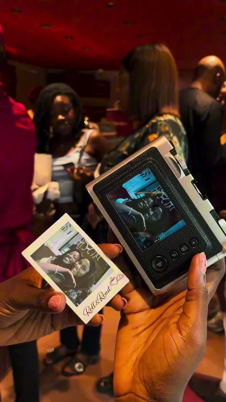 An instant camera and a printed portrait of two guests at Roll & Roast.